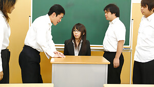 Sexy and arousing dark haired teacher Maho Sawai with glasses gets her black suit taken off and her hairy natural slit rammed pretty hard by a group of her turned on students after the class is over in a nasty group sex session on the desk and moansvideo